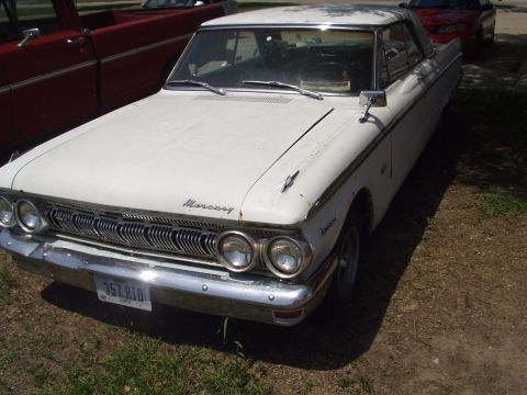 1979 Ford Bronco - Front view of a white 1962 Mercury sedan, showing its distinctive grille and headlights.