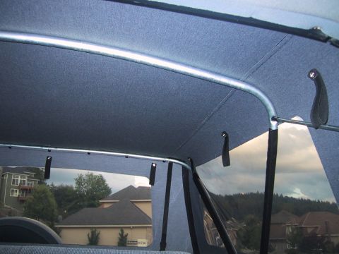 1989 Ford Bronco - The interior soft top of a 1989 Ford Bronco is visible, with a view of houses and trees through the windows.