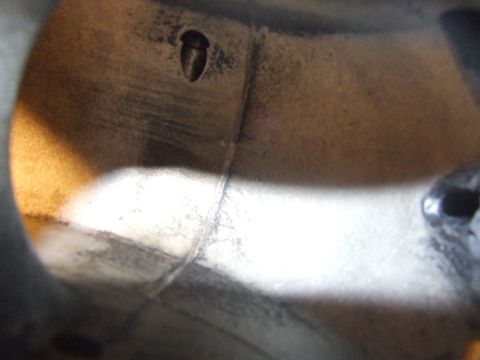 2003 Ford Crown Victoria - This is a close-up, interior view of a metallic cylinder, possibly a part of an engine or exhaust system. The surface shows signs of wear a…