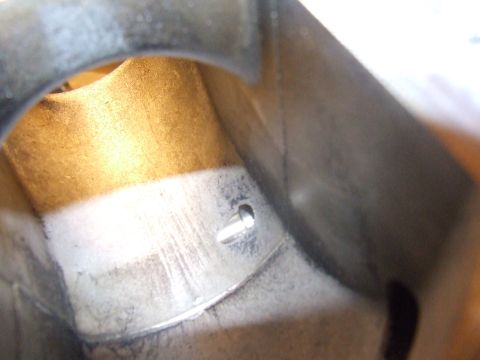 2003 Ford Crown Victoria - Interior view of a metal component with a small screw visible on the left side. The surface shows signs of wear and has a textured, slightl…
