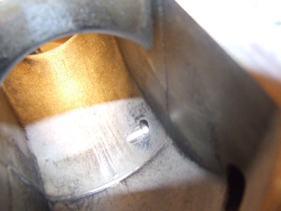 Interior of a metal part with a screw.