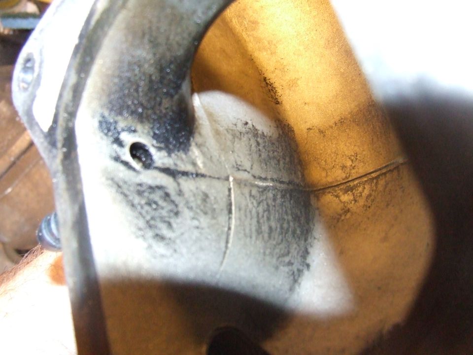 Cracked metal automotive part with carbon buildup