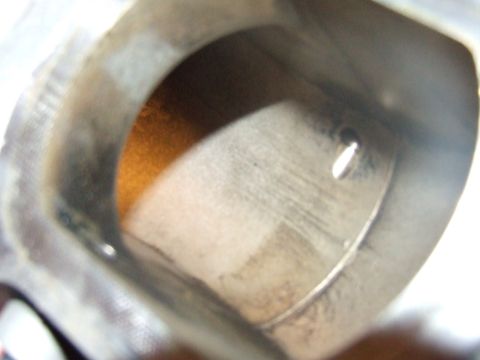 2003 Ford Crown Victoria - This is a close-up view inside a cylinder bore, showing the cross-hatching marks from machining and a small hole likely for a valve.