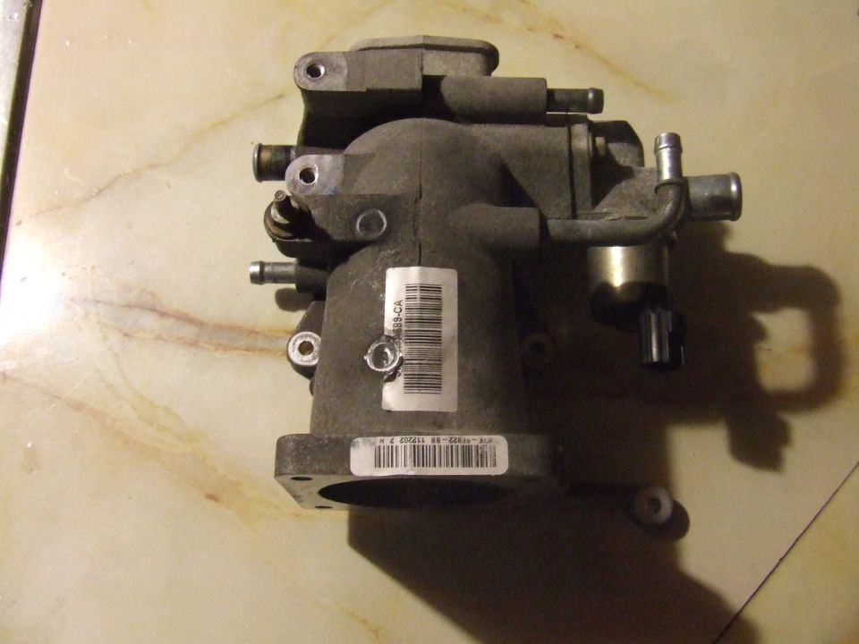 Gray automotive throttle body assembly with barcode label