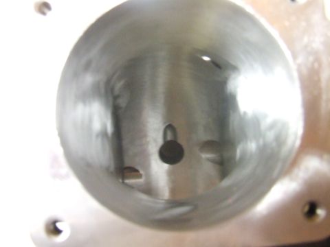 2003 Ford Crown Victoria - Close-up view inside a metallic cylinder with a small dark object in the center and several small openings around the inner wall. The cylin…