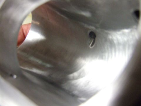 2003 Ford Crown Victoria - A close-up view inside a metallic tube or pipe, with a small black object with a silver ring attached to it visible on the interior surface…