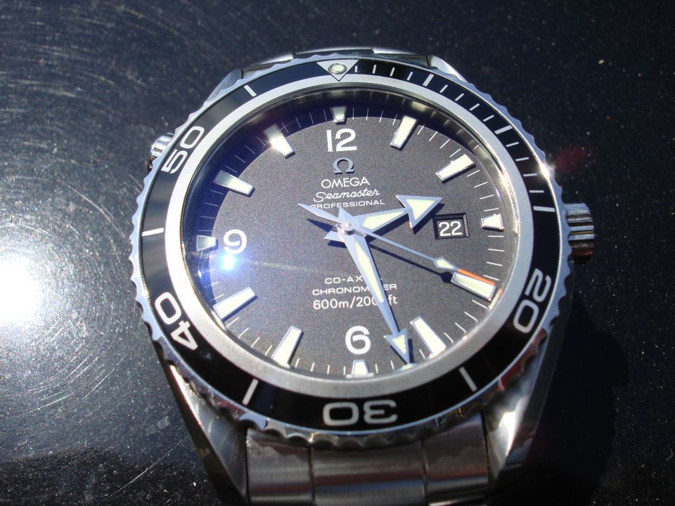Omega Seamaster Professional dive watch with black dial and stainless steel bracelet.
