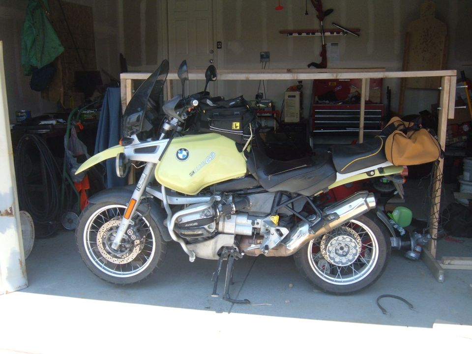 Yellow 1998 BMW R1100GS ABS motorcycle parked in a garage.