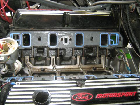 1988 Mercury Grand Marquis - The image shows the intake manifold gaskets being installed on a V8 engine. The Ford Motorsport valve covers are visible below the intake m…