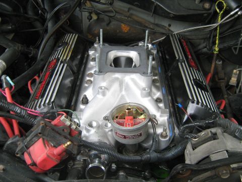 1988 Mercury Grand Marquis - A close-up view of the engine bay of a Mercury Grand Marquis, focusing on the intake manifold, valve covers, and ignition components.