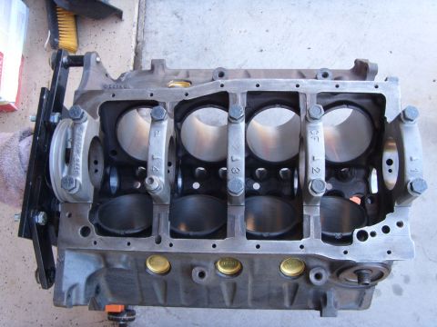 1989 Ford F-250 - A disassembled V8 engine block is shown from a top-down perspective, with the crankshaft bearing caps installed. The cylinder bores are cle…