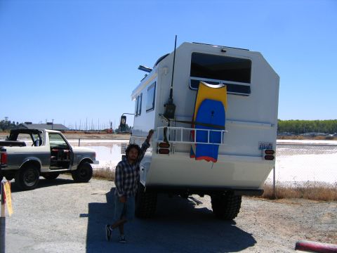 1991 Ford Bronco - A man stands next to a Ford Bronco and a large RV on a sunny day.