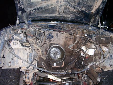 1991 Ford Bronco - The engine bay of a 1991 Ford Bronco is shown with the hood open and the engine partially disassembled. Various hoses, wires, and parts of…