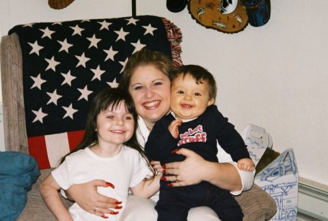 1995 Ford Bronco - A smiling woman poses with two happy children in front of a patriotic blanket.
