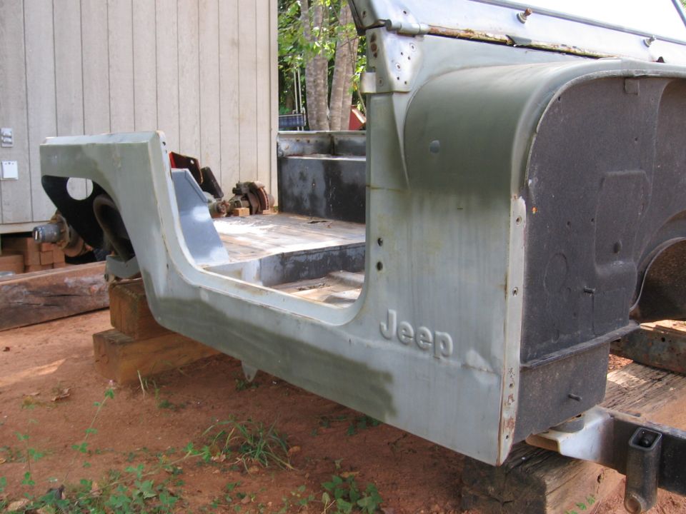Jeep CJ tub and frame, primer finish, side view, outdoors