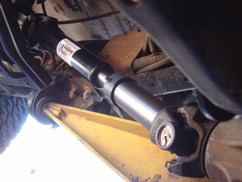 1986 Ford Bronco II - A vehicle's driveshaft and U-joint assembly are shown from a low angle.