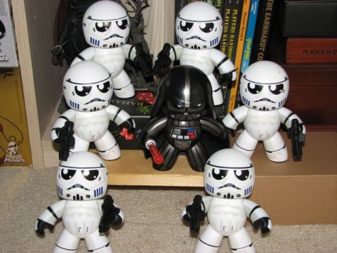 1991 Ford Bronco - Several Star Wars figures, including Darth Vader and stormtroopers, are displayed on a shelf with books and other items.