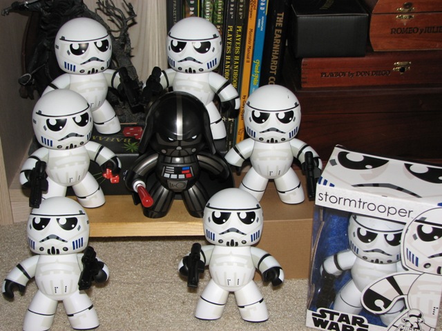 Stormtrooper and Darth Vader toys on a shelf