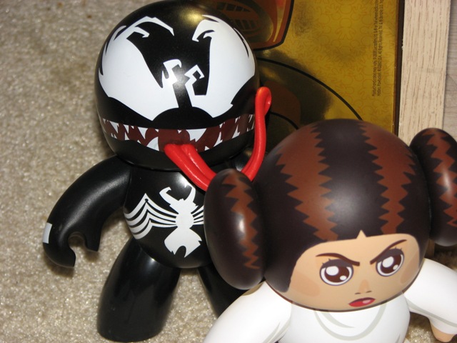 Venom figure with red tongue out next to Princess Leia figure