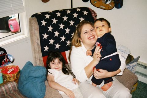 1995 Ford Bronco - A family enjoys time together in their living room, with an American flag blanket as a backdrop.