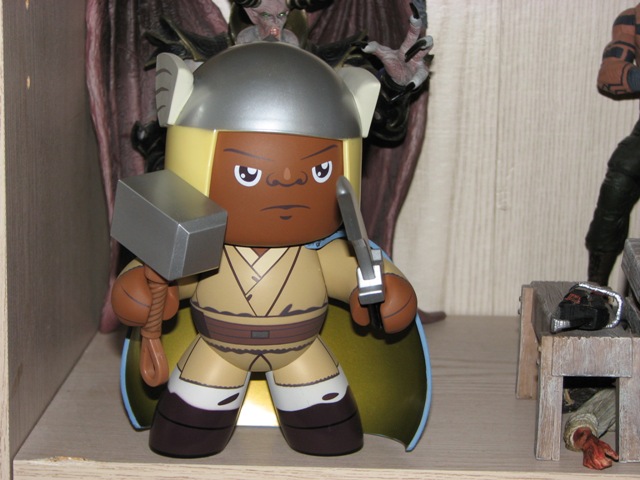 Toy figure with hammer and sword on a shelf