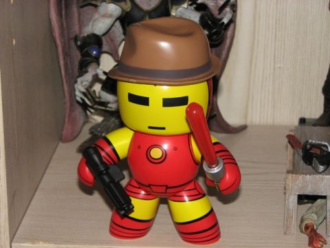 1991 Ford Bronco - A toy Iron Man figure stands on a shelf, accessorized with a hat and weapons.