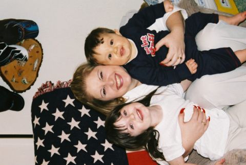 1995 Ford Bronco - A mother and two children are pictured together on a blanket.