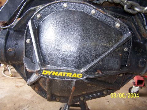 1979 Ford F-150 - A Dynatrac branded cover is bolted onto the rear axle of a vehicle, with a date stamp of 03/06/2004 visible.