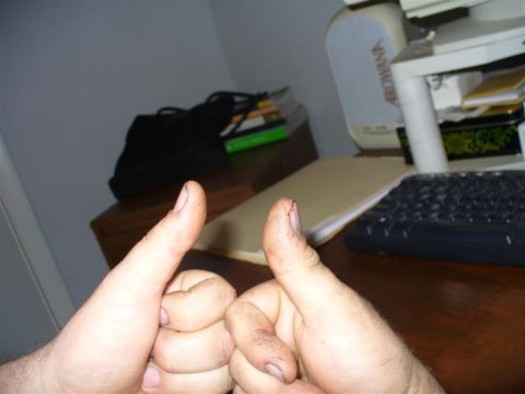 1988 Ford Bronco - A person gives a double thumbs-up gesture in front of a desk setup, with a computer and other office items visible in the background.