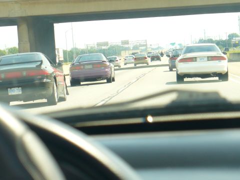 1993 Ford Probe - A purple 1993 Ford Probe is seen from behind on a busy highway.