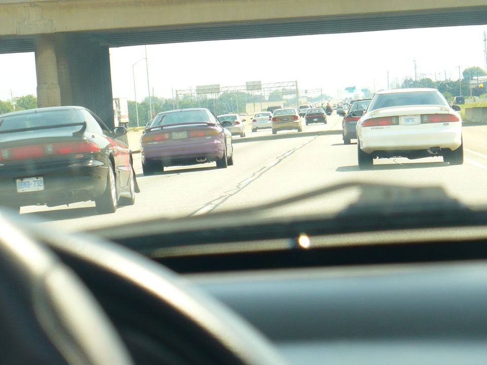 Rear view of purple 1993 Ford Probe on highway