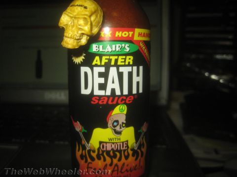 1968 Ford Mustang - Blair's After Death Sauce bottle features a skull charm and fiery graphics, with text indicating chipotle flavor.