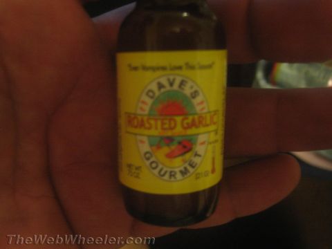 1968 Ford Mustang - A bottle of Dave's Roasted Garlic Gourmet Hot Sauce is held in a hand.