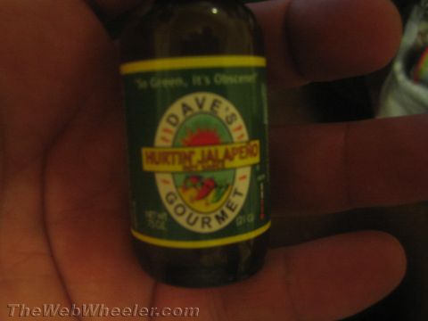 1968 Ford Mustang - Dave's Gourmet Hurtin Jalapeno hot sauce bottle is held in a hand.