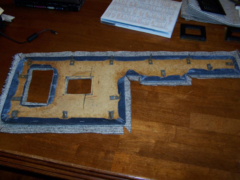 Door panel insert with blue trim and cutouts for hardware