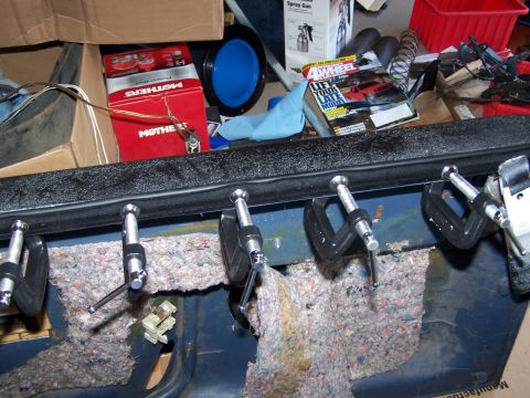 1986 Ford Bronco - A disassembled door panel is held together with clamps and insulation.