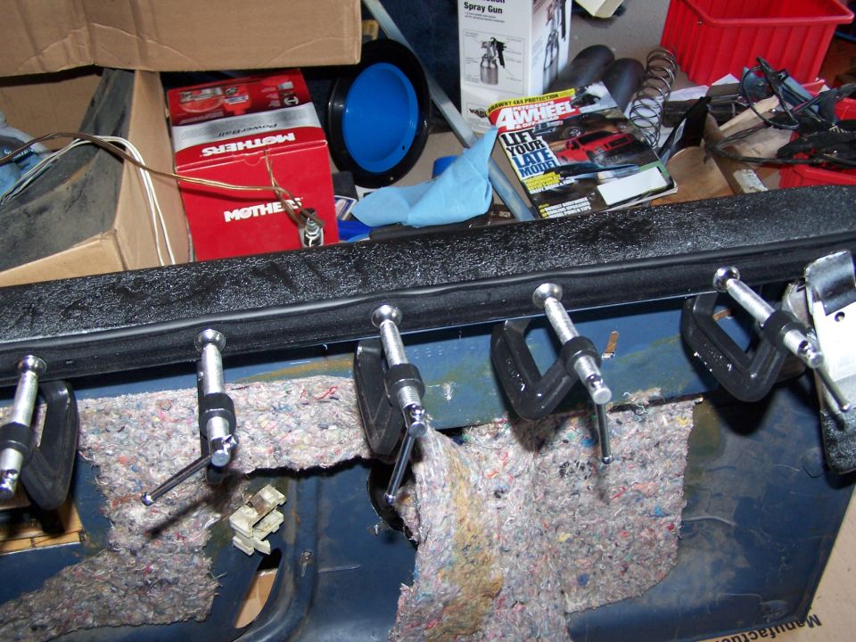 Door panel with insulation and clamps, showing blue metal interior