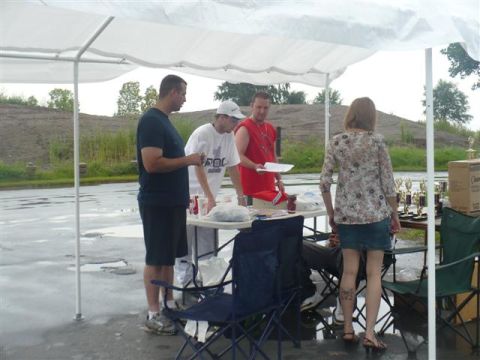 1993 Ford Probe - People are registering for an event at a table set up outdoors under a canopy.