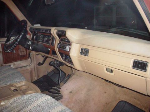 1984 Ford Bronco - Interior shot of a truck, showing the dashboard, steering wheel, and floor shifter.