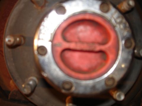 1996 Ford F-150 - A close-up view of a red and silver hub assembly with visible bolts. The hub appears to be on a vehicle wheel.