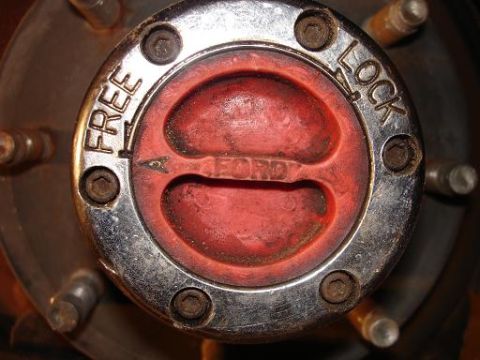 1996 Ford F-150 - A close-up view of a chrome hub with red lettering that reads "FREE" and "LOCK" and "FORD" in the center. The hub is attached to a vehicle…