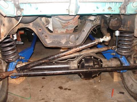 1996 Ford F-150 - The underside of a vehicle's suspension system, featuring a differential, springs, and steering components, is shown in this close-up view.