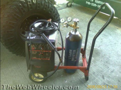 1987 Suzuki Samurai - Photograph of a Hobart welder with shielding-gas cylinder on a cart, not a technical document.