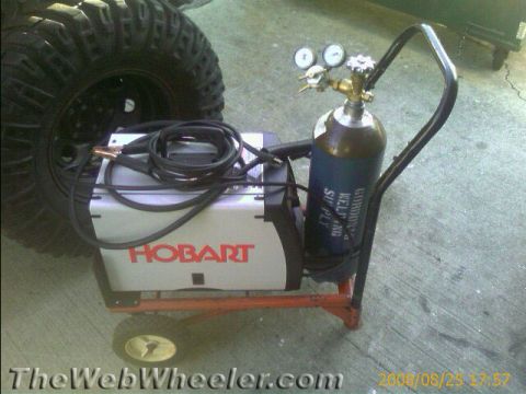 1987 Suzuki Samurai - Photograph of a Hobart welder and shielding-gas cylinder, not a technical document.