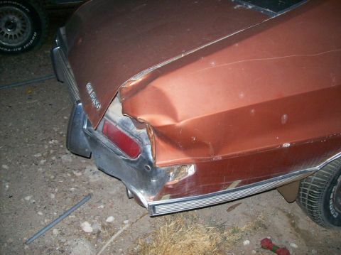 1975 Ford Ranchero - The rear driver's side of a damaged copper-colored 1975 Ford Ranchero is shown. The vehicle has significant damage to the quarter panel and…