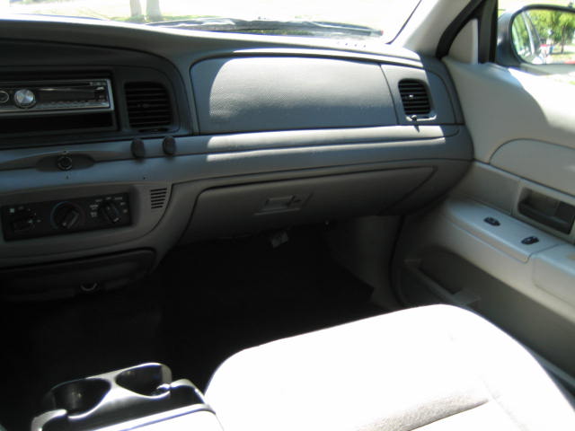 Interior of a Ford Crown Victoria showing the dashboard, radio, and center console.