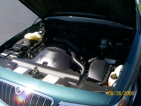 1995 Mercury Grand Marquis - Engine bay of a teal-green Mercury sedan with hood open, showing the air intake, fan shroud and reservoirs; date stamp 08/26/2008.