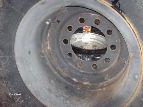 1990 Ford F-150 - A close-up view of a spare tire and wheel assembly, with a plastic bottle inside the wheel rim. The tire has a date stamp of 20/08/2008.