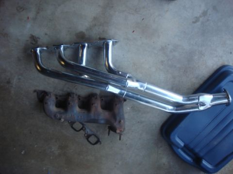 1983 Ford Bronco - here is the stock manifold and the new header. the header will flow alot more air and keep the temp down some.