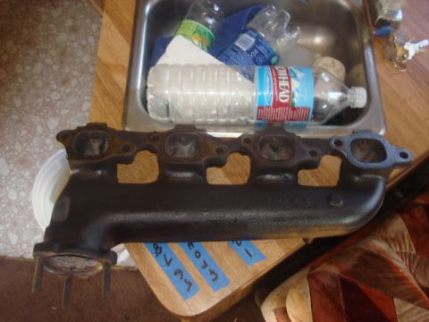1983 Ford Bronco - i cleaned up the exhaust manifold and primed and painted it. I then cleaned the gasket area. this turned out real good